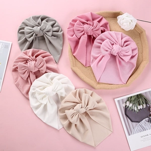 Close-up of baby ribbed cotton turban hats with large bows in six assorted soft colors