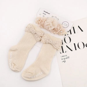 Detailed set of baby floral headband and ribbed socks with lace bows in beige cream