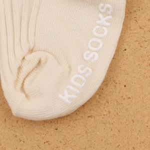 Close-up of baby socks with ribbed knit texture and anti-slip silicone grip on the sole
