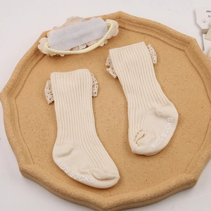 Infant socks and headband set with lace trim in cream white ribbed cotton fabric