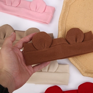 Detail view of soft knitted cotton baby headbands with cute animal ear decorations