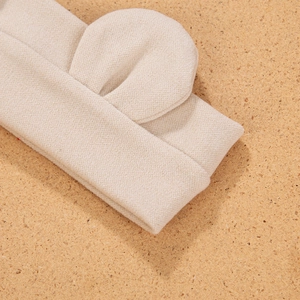 Macro detail of soft knit bear ear headband in beige for infants and toddlers