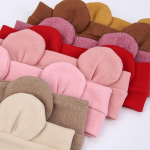 Detailed pile of colorful knitted baby headbands with cute round bear ears for infants