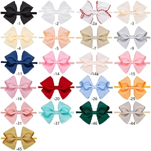 Detailed grid of multicolored embroidered bow headbands for infants in 21 varied shades