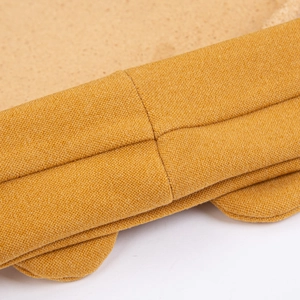 Close-up of mustard yellow fabric headband with precise cross-stitch sewing details
