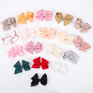 Flat lay of colorful 17-piece ribbon bow hair clip set with jagged edge detail on white