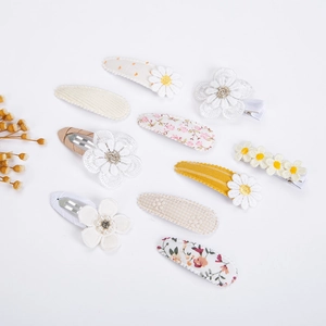 Detail view of 10pcs floral fabric hair clips set with embroidery and lace details