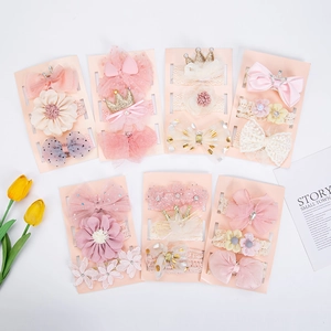 Close-up of baby headband set featuring lace flowers, mesh bows and sequin crowns