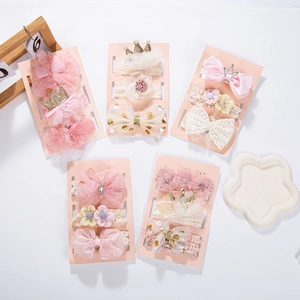 Detail of infant headband set featuring lace bows, mesh flowers and faux pearls