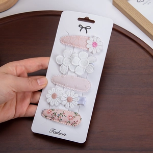 Detailed close-up of 5-piece floral BB hair clip set with pink lace and embroidery