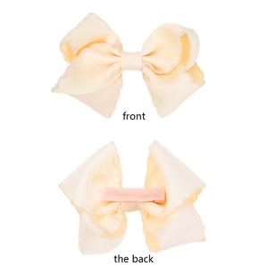 Detailed front and back view of a yellow scalloped grosgrain ribbon bow hair clip