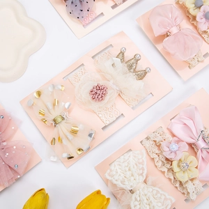 Close-up of baby girl lace headbands and clips with floral embroidery and satin bows