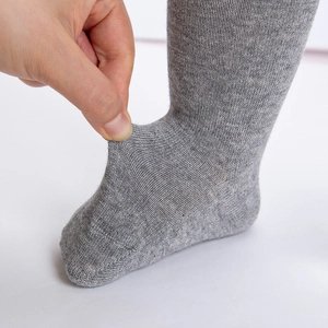 Detailed view of high elasticity grey knitted baby socks showing flexible stretch fit