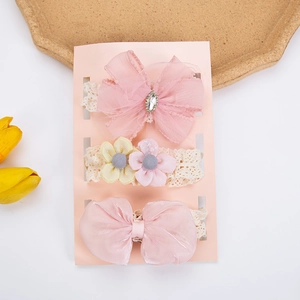 Detailed macro view of 3-piece baby headband set with pink tulle bows and lace flowers