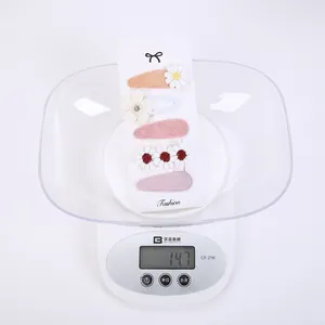 Detailed weight measurement of a 5-piece floral hair clip set on a digital scale