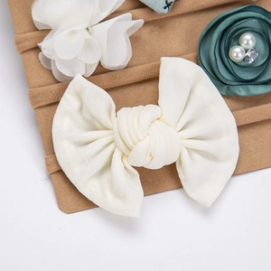 Detail of baby headband set with chiffon flowers and velvet roses on nylon bands