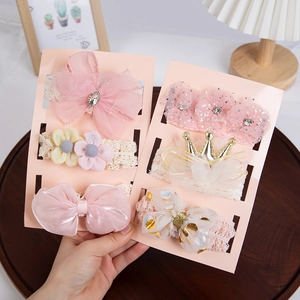 Detailed view of elastic lace headbands with fabric flowers and bows for baby girls