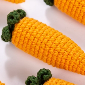 Handcrafted crochet carrot pendants with orange and green yarn for Easter decor