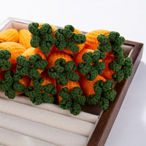 Close-up of handmade crochet mini carrots for DIY crafts and Easter decorations