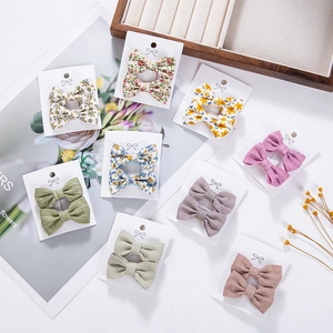 Floral cotton bow hair clips set for girls in various pastel colors on a display card