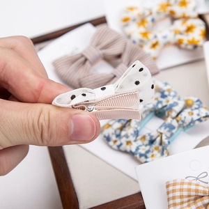 Detail of fabric bow hair clips with metal alligator clips and ribbon lining