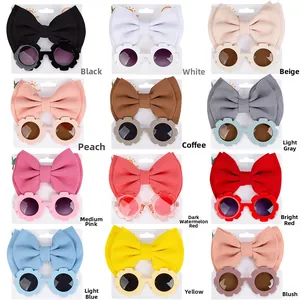 Kids' set featuring 12 colors of flower sunglasses and matching waffle bow headbands