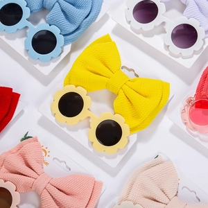 Close-up of baby sunflower sunglasses and matching waffle fabric bow headband set in various colors