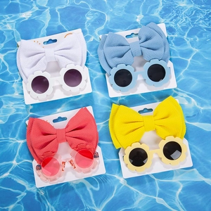 Detail view of baby flower sunglasses and matching waffle bow headbands set in vibrant colors
