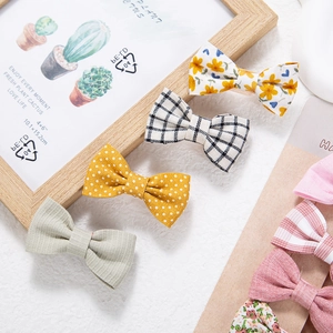 Detail of fabric hair clips featuring floral, plaid and polka dot patterns for children