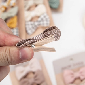Handmade striped cotton bow hair clip for infants with fabric-wrapped non-slip design