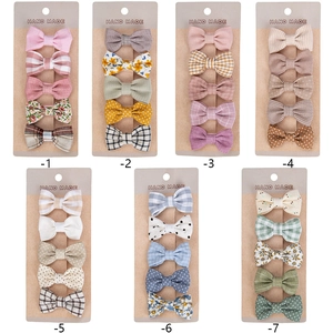 7 sets of 5 cotton fabric bow hair clips for infants in various patterns and soft colors