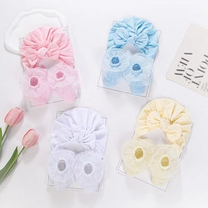 Detailed set of baby headbands and socks with lace edges in four soft pastel colors