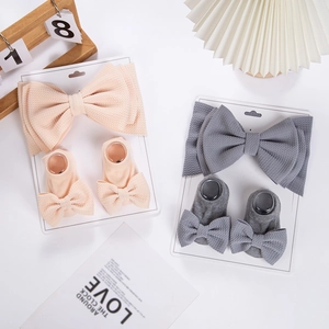 Baby bow headband and socks gift set made of textured stretch knit in soft warm tones