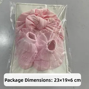 Pink cotton baby turban hat with bow and lace socks set in clear retail packaging