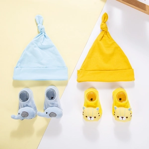 Detailed set of blue and yellow knit baby hats and socks with cute animal embroidery