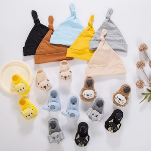 Detailed set of knit baby hats and matching socks with cute 3D cartoon animal patterns