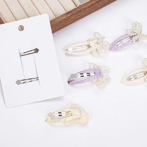 Elegant Korean style hollow pearl bow hair clips in cream and light purple shades