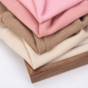 Detail showing soft cashmere knit texture in pink, tan, and beige for baby warm hats