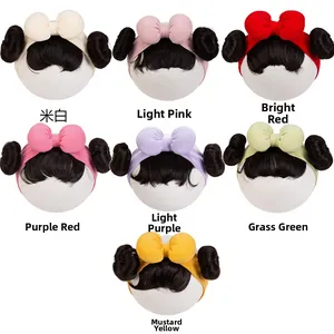 Detail of infant cotton headbands with large bows and twin bun hair decorations