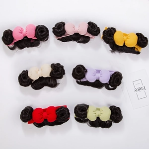 Flat lay of seven colorful baby bow headbands with cute double bun wig hairpiece details