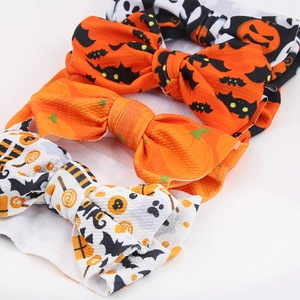 Detailed set of three Halloween baby headbands featuring pumpkin and bat prints