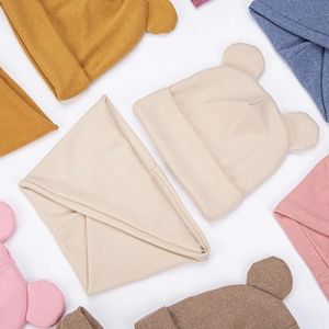 Detail shot of multi-color knit baby bear hats and matching triangular scarves set