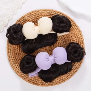 Close-up of baby hairbands with cotton bows and cute synthetic bun hairpiece details