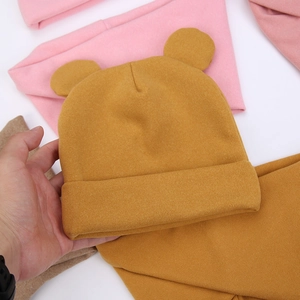 Detailed knit texture of ginger baby bear hat with cute ears and folded brim