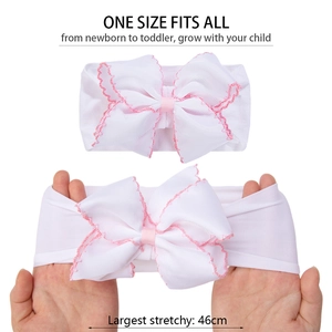 Detail showing the white nylon baby headband stretching up to 46cm with a large pink bow