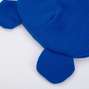 Close-up of royal blue knitted baby hat featuring cute bear ears and soft texture detail