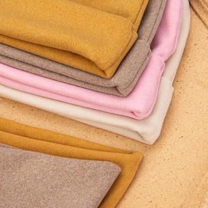 Detailed close-up of knitted bear hats and scarves showing texture in multiple colors