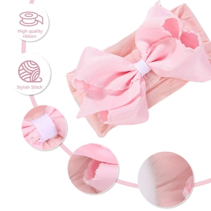 Detail of pink baby headband showing high quality ribbon bow with stylish stitch accents