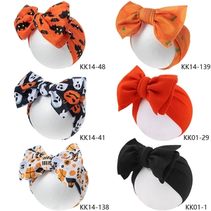 Set of six Halloween baby headbands with large bows featuring pumpkin and bat prints