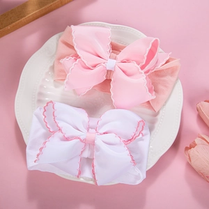 Soft elastic nylon baby headbands with large scalloped ribbon bows in pink and white